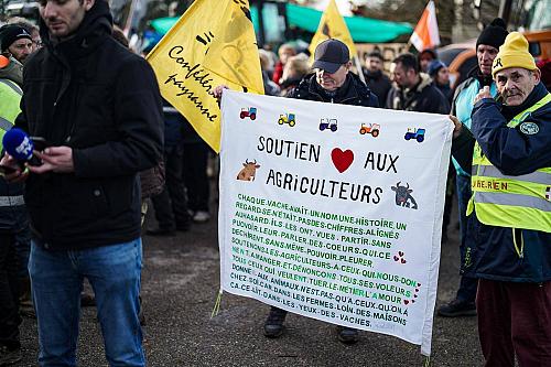 une banderole "soutien aux agriculteurs" avec un coeur est déployée