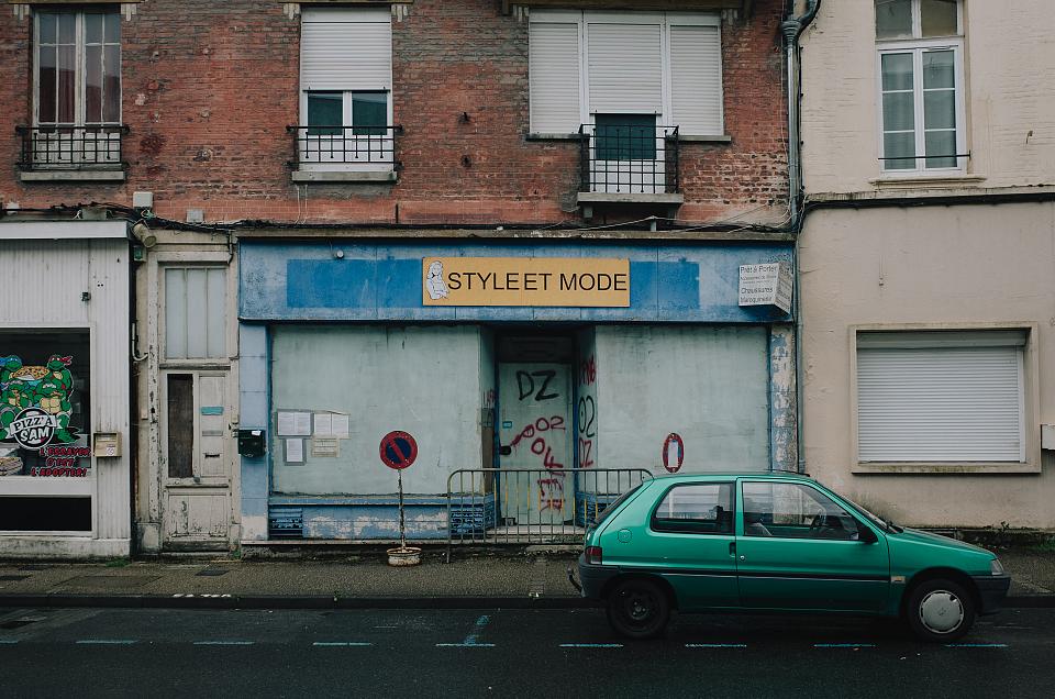 Vue d'une boutique fermée, aux vitrines murées
