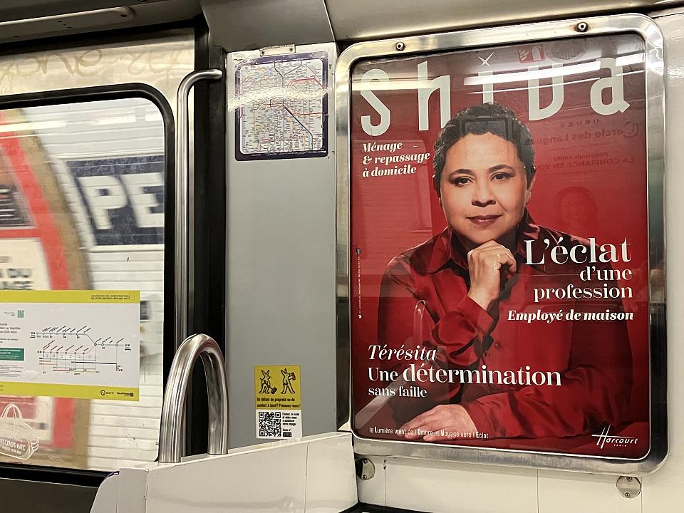 Une publicité pour Shiva dans une voiture de métro : une femme photographiée sur fond rouge par le studio Harcourt. 