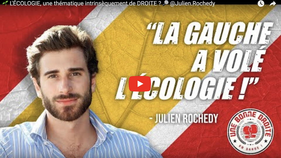 Capture d'écran d'une vidéo de Julien Rochedy. L'homme barbu sourit sur un fonds rouge, blanc, jaune avec un écusson en bas à droite. Il est écrit "La gauche a volé l'écologie"