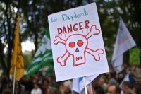 Une pancarte avec le message « Loi Duplomb danger », avec un dessin d'une tête de mort. 